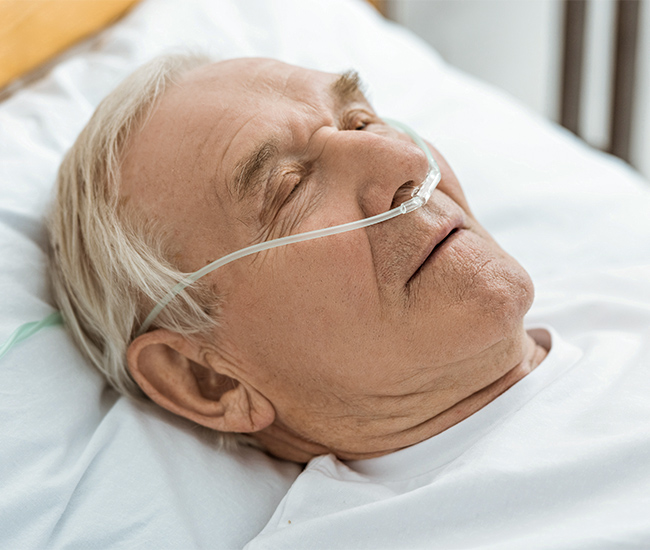 Aveiro-SleepApneaTest Older man sleeping with the assistance of a nasal cannula